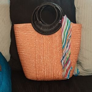 Orange straw bag with brown wood handles, one inside pocket. Scarf is included